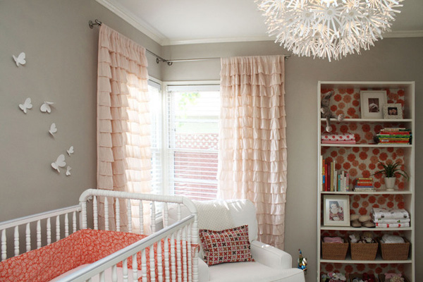 Pretty coral and gray nursery with ruffled curtains