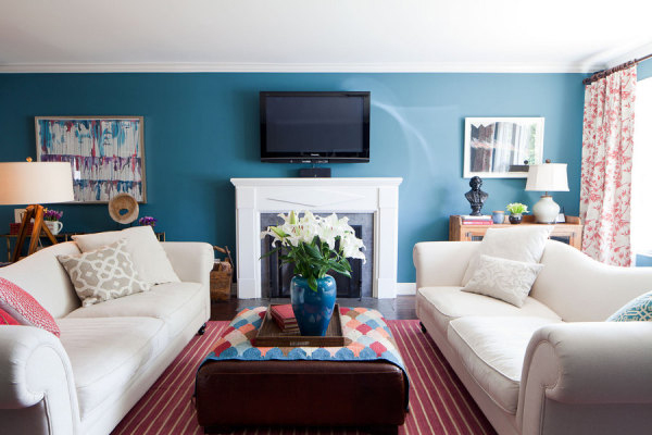 Darl teal and red living room with fireplace