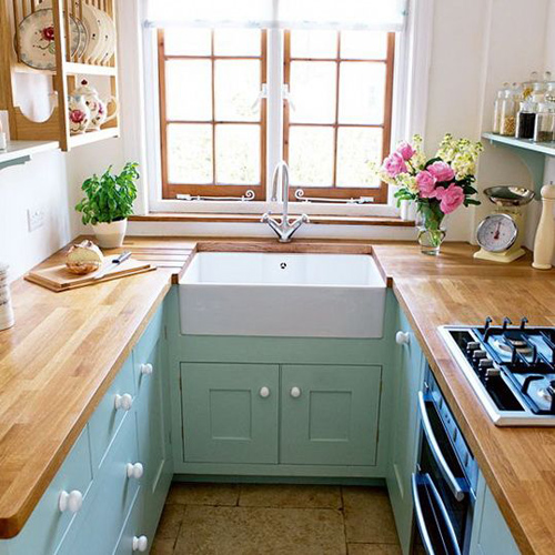 Mint and wood kitchen with butchers block counters and farmhouse sink