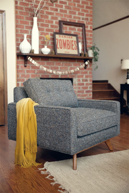 Red brick fireplace with garland and zombie warning sign