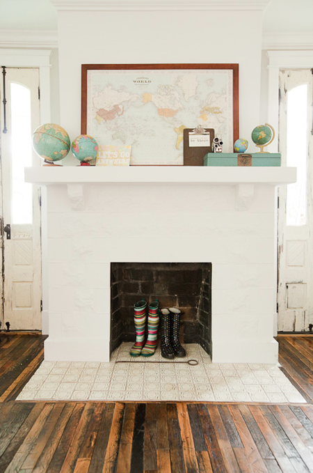 Maps and globes and galoshes fireplace mantel