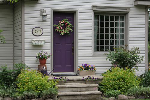 Plum front door with taupe trim
