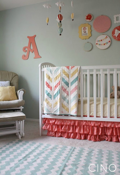 Pretty girl's nursery with teal walls and coral and yellow accents